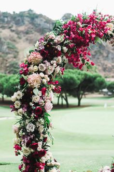 a floral arch on the side of a golf course