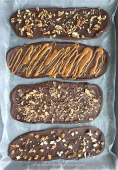 four chocolate treats are lined up on a baking sheet and ready to go into the oven