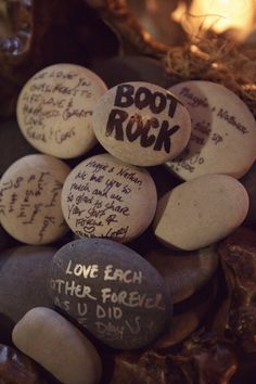 some rocks with writing on them are in a bowl