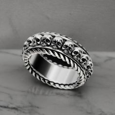 Unleash your edgy style with our Thick Ring with Skulls, meticulously crafted from high-quality 925 Sterling Silver. This bold and heavy ring features a detailed design of multiple skulls, symbolizing strength, mystery, and resilience, making it a standout piece for both men and women. Perfect for adding a daring statement to any outfit, this ring is ideal for everyday wear or special occasions. Handmade with exceptional craftsmanship, the ring showcases intricate detailing and a polished finish Thick Ring, Viking Ring, Masonic Ring, Retro Ring, Animal Rings, Edgy Style, Jewelry For Men, Everyday Rings, Detailed Design