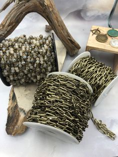 two spools of chain sitting on top of a table next to some other items