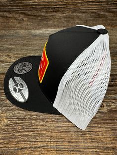 Introducing the 2361T-BKWH "Rank Stock" 5-Panel Trucker Cap by Hooey. This classic cap features a black and white design, with a pop of color from a vibrant red, white, and yellow patch. With an adjustable fit and curved bill, this high-profile cap is perfect for any event. Get your hands on this versatile and stylish cap from Hooey. Black Retro Hat For Sports Events, Black Retro Sports Baseball Cap, Retro Black Baseball Cap For Sports Events, White Hip Hop Snapback Hat With Curved Bill, White Retro Baseball Cap For Streetwear, White 5-panel Sports Hat, Retro Black Fitted Cap, Retro White Fitted Hat With Curved Brim, Hip Hop Black Trucker Hat For Sports Events