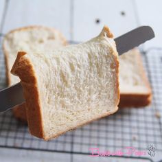 two pieces of bread with a knife sticking out of it