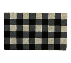 a black and white checkered rug on a white background