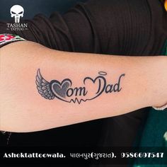 a man with a tattoo on his arm that says om dad and an angel wing