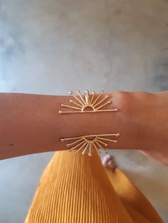 This unique wrist cuff bracelet is a statement piece, feminine and complementing. Its' design is inspired by the sun and is adjustable.- Length- 5.7 inches (14.5 cm)If you need a different size, just specify in the note to seller and I will comply :)- Width- the sun part measures about 2 inches wide (5 cm)- Material- 24k gold over brass (nickel free) or solid sterling silver- Arrives in a lovely gift box, ready to give as a gift- Ships within 3 business daysPart of my new "Zoa" collection- Zoa m Gold Sun Bracelet, Statement Bracelets Cuffs, Sun Inspired Jewelry, Gold Cuff Bracelet Women, Unique Jewelry Inspiration, Cuff Bracelets Gold, Brass Jewelry Design, Sun Clothes, Gold Jewelry Bracelets