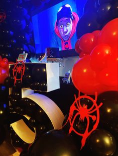 balloons and decorations are on display in front of a television screen with an animated character