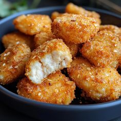 fried chicken nuggets in a blue bowl with parmesan sprinkles