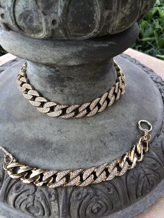 "This vintage necklace and bracelet set makes a very impressive presentation. They have both polished gold tone and rhinestone pave links which creates a whole lot of \"bling\". The necklace is 17\" in length and 5/8\" wide (weight is 130 grams). The bracelet is approximately 8\" in length (weight is 55 grams). If so desired the necklace can be worn in reverse in which case the look will be simply that of a highly polished gold tone necklace. (see photo #4) This reversibility gives the wearer th Gold Cuban Link Necklace With Rhinestones, Gold Diamond Chain Bracelet With Rhinestones, Gold Cuban Link Jewelry With Rhinestones, Gold Chain Link Bracelet With Diamond Accents, Gold Rhinestone Chain Necklace For Formal Events, Formal Gold Rhinestone Chain Necklace, Gold Chain Necklace With Rhinestones And Cubic Zirconia, Gold Cubic Zirconia Chain Necklace With Rhinestones, Gold Chain Link Necklace With Bling