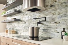 a stove top oven sitting inside of a kitchen next to a wall mounted range hood