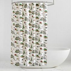 a shower curtain with trees and houses on it in front of a white bathtub