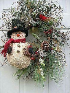 a snowman wreath hanging on the front door