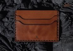 DESCRIPTION The Slim Wallet is one the most simplistic wallet styles offered. It features five pockets, four on the outside that allow for easy access to cards and one in the middle for stashing cash or more cards. The Slim Wallet is saddle stitched by hand, joining each leather piece together with a durable poly cord thread. The saddle stitch technique has been favored for centuries by expert leather workers, and has a distinct durability advantage when compared to the lock stitch technique use Lock Stitch, Saddle Stitch, Slim Wallet, Leather Pieces, Wallet Fashion, Vegetable Tanned Leather, Corporate Gifts, Watch Strap, Easy Access