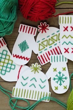 knitted christmas stockings and mittens ornament craft kits on a wooden surface