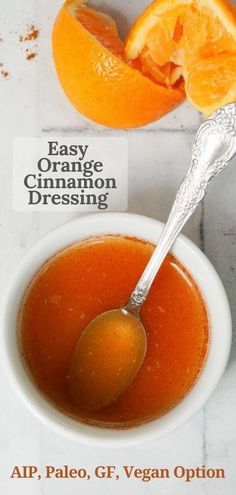 an orange is next to a bowl of soup and a spoon with the word easy orange cinnamon dressing on it