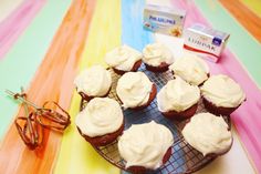 cupcakes with white frosting sitting on a cooling rack