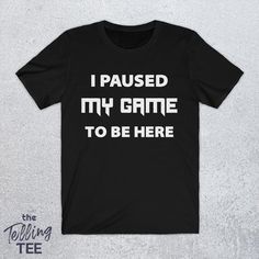 I Paused My Game To Be Here Shirt | Funny Gamer Shirt | Sarcastic Gamer Tee | Funny Gamers Gift by TheTellingTee ------------ https://etsy.me/2ZEqMlD Funny Gamer Shirt, Gamer Shirt, Gamer Humor, Sarcastic Shirts, Gamer Gifts, I Am Game, Mens Gifts, Shirt Designs, T Shirts For Women