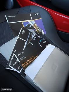 several business cards sitting on the back seat of a car