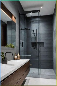 a bathroom with a walk in shower next to a sink