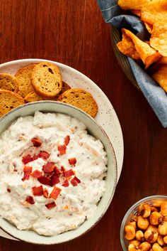 a bowl of dip and crackers on a table