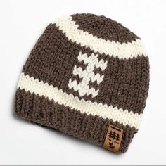 a brown and white knitted hat on a white background