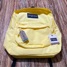 Jansport Backpack Is Our Top Backpacks For College And High School Students. The Brand Jansport Has School Backpacks, That Are Very Durable And Lightweight Making Them Great Hiking Backpack. Backpacks Are Essential For Grade-School Kids. Brand: Jansport Color: Pale Banana (Yellow) Size: 16” X 12” X 5” Approx Condition: Brand New With Original Tags Jansport Backpack For School | Jansport Backpack For Travel | Jansport Backpack For Hiking | Jansport Sustainable Traveling Backpack | Jansport Backpa Yellow Standard Backpack For Outdoor Activities, Yellow Bags For Back To School, Yellow Backpack For Outdoor Activities, Yellow Backpack For Outdoor Activities And Back To School, Functional Yellow Nylon Backpack, Back To School Yellow Backpack For Outdoor Activities, Yellow Outdoor Backpack, Sporty Yellow Nylon Bag, Functional Yellow Sports Bag