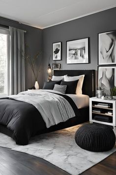 a black and white bedroom with pictures on the wall