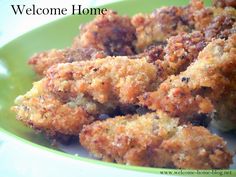 a green plate topped with fried food and the words welcome home on it's side