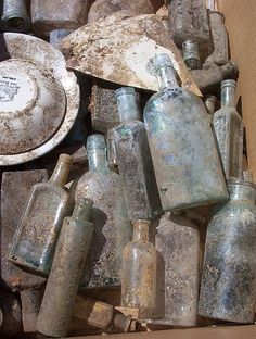 an open box filled with lots of old bottles