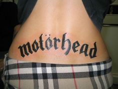 the word motorhead written in cursive black ink on a woman's lower back