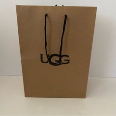 Ugg Shoe Gift Bag Brown Paper Bag With Rope Handles. Perfect For Shoes Or Small Winter Accessories. Bundle With My Ugg Tasman Slippers Or Ugg Classic Ultra Mini Boots. Height 14” Width 10” Depth 6.5” Handle Drop 8” Fits One Shoe Box (For Slippers Or A Similar Size) Ships Within One Business Day Packaged With Care Ugg Shoe, Ultra Mini Boots, Ugg Bag, Tasman Slippers, Mini Boots, Ugg Tasman Slippers, Ugg Classic Ultra Mini, Limited Edition Bag, Holiday Gift Bag