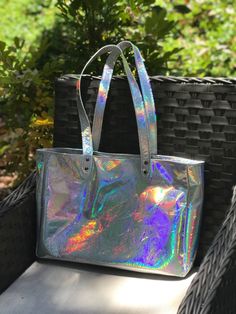 Large Holographic Leather Tote Handmade in Australia - Smooth soft holo leather - shown with gunmetal hardware and Lining 4 inside: Magnetic closure or choose zipper close 3 slip pockets Swivel clasp for keys Outside: - Strong Flat Shoulder Straps, stitched and riveted. Length 69cm. - Metal feet on bottom Size: Length: 40cm (15.7 inch) Depth: 10cm (3.9 inch) Height: 28cm (11 inch) * An everyday bag, fitting everything you need. * Fully lined in your choice of quality lining fabric (see options) Metallic Rectangular Shoulder Bag For Everyday, Iridescent Rectangular Travel Bag, Trendy Iridescent Bag For Everyday Use, Iridescent Trendy Bag For Everyday Use, Trendy Iridescent Bags For Everyday Use, Iridescent Rectangular Shopping Bag, Holographic Fashion, Gunmetal Hardware, Oversized Tote