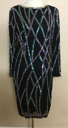 This Oleg Cassini dress is in good preloved condition. I am sure it has some missing sequins and beads but they are not noticeable/hard to find. It has shoulder pads. No built in padding. Dress is a little heavy in weight. Size: 10 Measurements: Bust: 34 in. Waist: 32 in. Hip: 38 in. Length: 39 in. Shoulder to shoulder: 18.5 in. Sleeve Length: 23 in. Material: Shell: 100% Silk. Lining: 100% Rayon. Made in China. **NO RETURNS**  *All sales are final* Due to the preloved condition, we don't want o Oleg Cassini, Green Blue Purple, Holiday Dress, Dress Clothes For Women, Holiday Dresses, Black Beads, New Years Eve, Black Tie, Vintage Tags