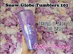 a hand holding a purple starbucks cup with the words, snow globe tumblers 101 taking it back to the basics