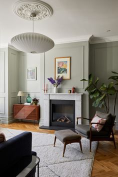 a living room filled with furniture and a fire place in the middle of a room