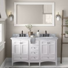 a bathroom with two sinks and a large mirror above it's counter top area