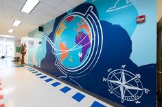 an office hallway painted with blue and white graphics on the wall, along with striped flooring