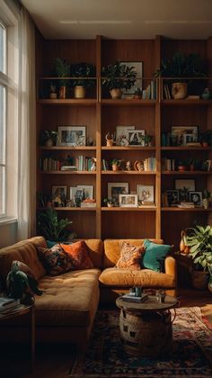 a living room filled with lots of furniture and bookshelves next to a window