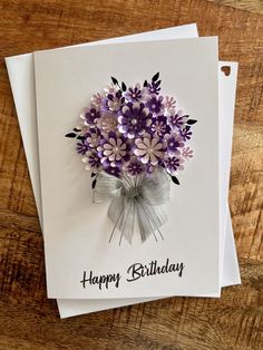 a birthday card with purple flowers on it