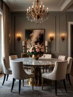 an elegant dining room with chandelier and marble table