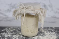 a jar filled with white powder sitting on top of a table