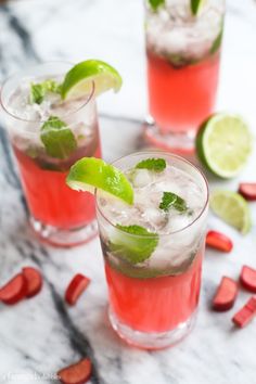 two glasses filled with watermelon and cucumber on top of a table