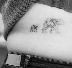 a woman's stomach with an elephant tattoo on it