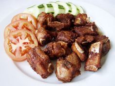 a white plate topped with meat and veggies