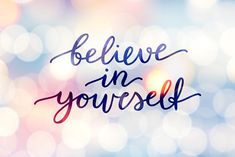 the words believe in yourself written on a blurry blue and pink background with boket