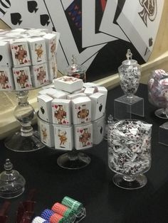 a table topped with lots of cards and vases on top of eachother