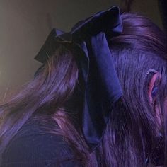 a close up of a person with hair in the back of her head and an ear piercing