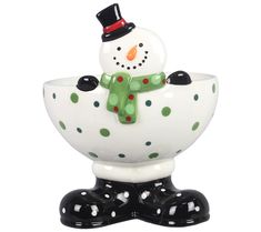 a ceramic snowman in a polka dot bowl