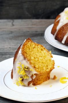 two white plates topped with bundt cakes covered in frosting and lemon zest