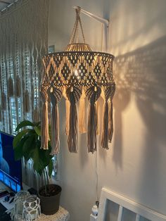 a chandelier hanging from the ceiling next to a laptop computer on a desk